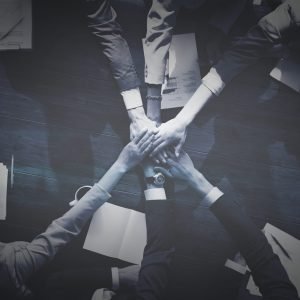 Business people stacking their hands